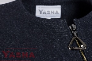 Rounded neckline and front zip with a triangular pull on the navy denim jacket